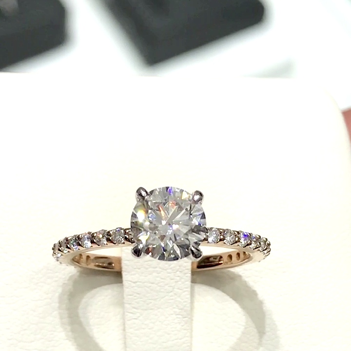 18kt Rose Gold Engagement Ring with 1.5 carat lab diamond at the center (Color: D | Clarity: VVS2 | Round Cut) and natural E / VVS grade Setting Diamonds. Solitaire Setting with Diamonds on the Shank.